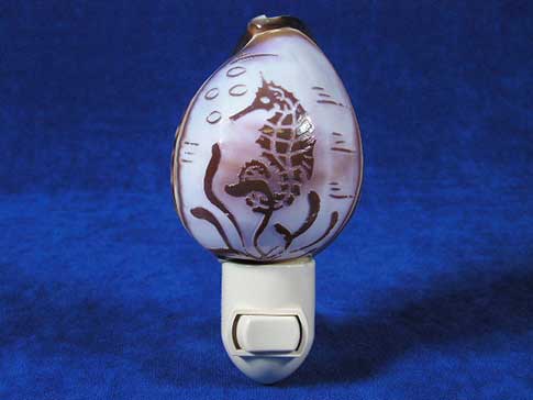 Seashell nightlight with a seahorse carved onto it.